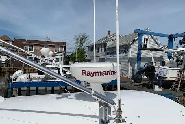 Slide: The Image of 2006 Regulator 24 Classic boat with Raymarine radar at a marina. - 11