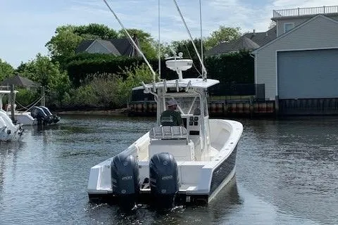 Slide: The Image of 2006 Regulator 24 Classic boat with dual engines on a calm waterway. - 13