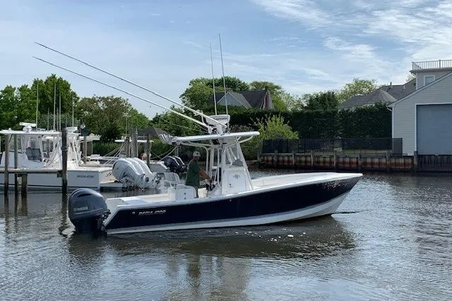 Slide: The Image of 2006 Regulator 24 Classic boat on water near docks and houses. - 16