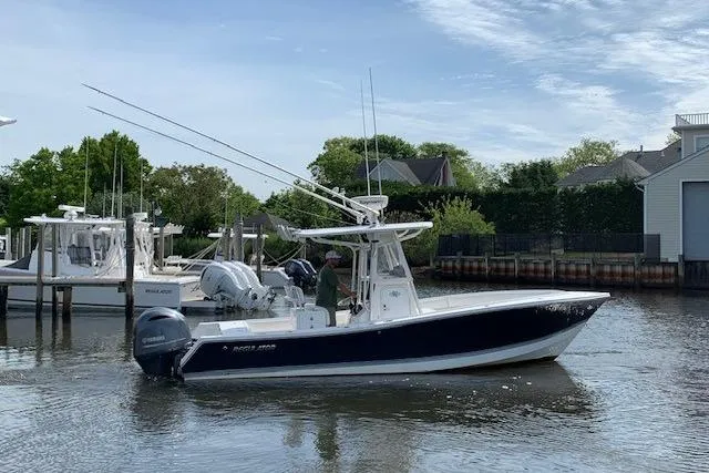 Slide: The Image of 2006 Regulator 24 Classic boat on calm water, featuring dual outboard motors. - 18
