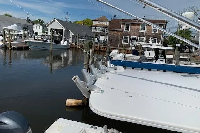 Slide: The Image of 2006 Regulator 24 Classic boat docked in a marina with waterfront buildings. - 29