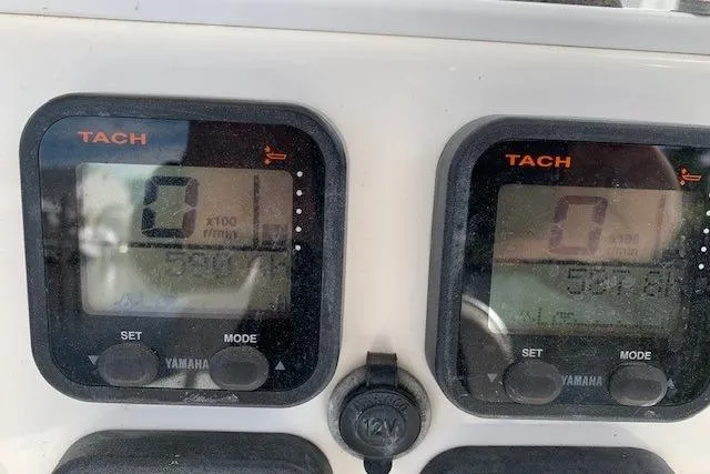 Slide: The Image of Close-up of Yamaha tachometers on a 2006 Regulator 24 Classic boat dashboard. - 32