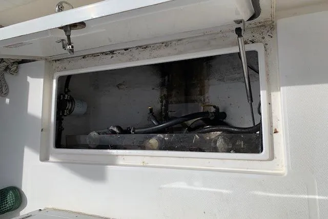 Slide: The Image of Open storage compartment on a 2006 Regulator 24 Classic boat, showing internal components. - 46