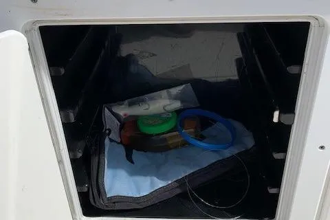 Slide: The Image of Storage compartment on a 2006 Regulator 24 Classic boat with fishing gear. - 47