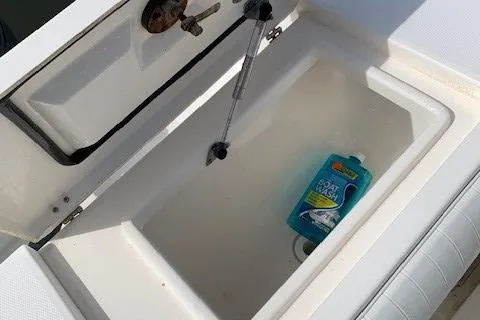 Slide: The Image of Open storage compartment on 2006 Regulator 24 Classic boat with cleaning product inside. - 52