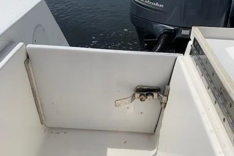 Slide: The Image of 2006 Regulator 24 Classic boat interior with open hatch and visible outboard motor. - 53