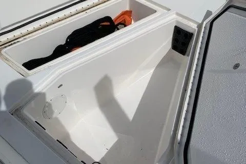 Slide: The Image of 2006 Regulator 24 Classic boat storage compartment with safety gear. - 56