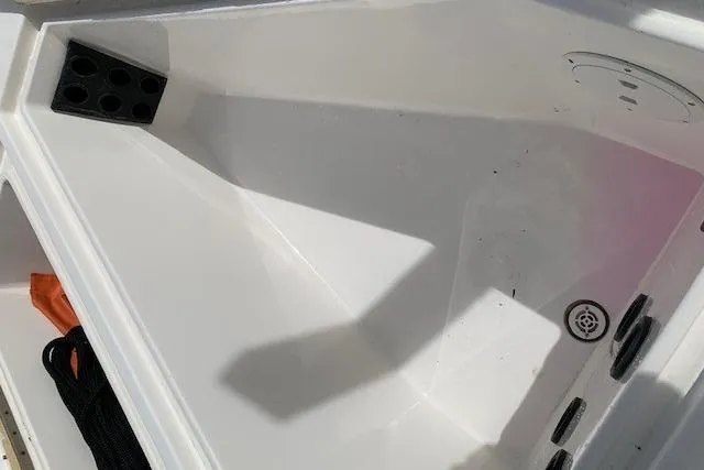 Slide: The Image of 2006 Regulator 24 Classic boat interior with storage compartments and drain. - 57