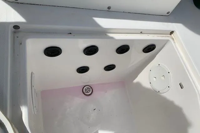 Slide: The Image of Livewell compartment of a 2006 Regulator 24 Classic boat, featuring drainage and aeration systems. - 58