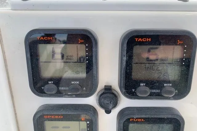 Slide: The Image of Dashboard of a 2006 Regulator 24 Classic boat with Yamaha tachometers and gauges. - 61