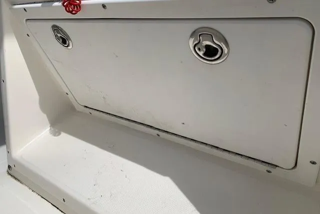 Slide: The Image of 2006 Regulator 24 Classic boat storage compartment with metal latches and white finish. - 66