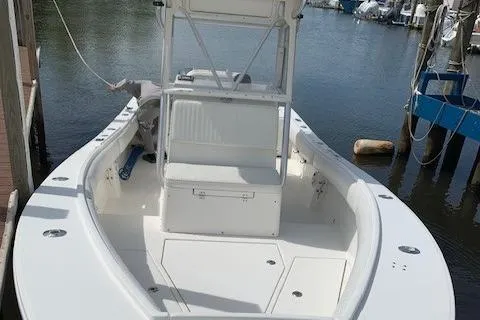 Slide: The Image of 2006 Regulator 24 Classic boat docked, showcasing spacious deck and seating area. - 72