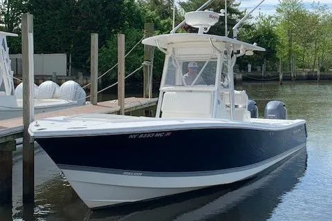Slide: The Image of 2006 Regulator 24 Classic boat docked on calm water, featuring a sleek design and modern equipment. - 79