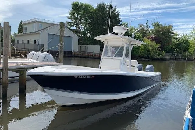 Slide: The Image of 2006 Regulator 24 Classic boat docked in a serene marina setting. - 81