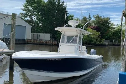 Slide: The Image of 2006 Regulator 24 Classic boat docked in a serene marina setting. - 82