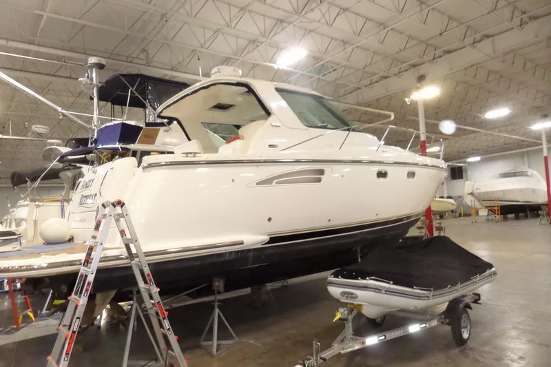 Slide: The Image of 2006 Tiara Yachts 3600 Sovran in indoor storage, with a small boat on a trailer nearby. - 1
