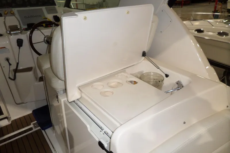 Slide: The Image of 2006 Tiara Yachts 3600 Sovran helm station with storage compartment and cup holders. - 13