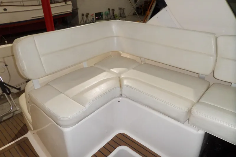 Slide: The Image of 2006 Tiara Yachts 3600 Sovran interior with white cushioned seating and wooden flooring. - 15