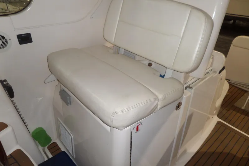 Slide: The Image of 2006 Tiara Yachts 3600 Sovran interior with white cushioned seating and wooden flooring. - 16