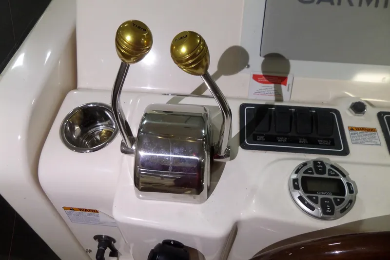 Slide: The Image of Control panel of a 2006 Tiara Yachts 3600 Sovran with throttle levers and switches. - 21