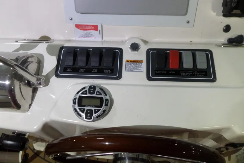 Slide: The Image of Control panel of a 2006 Tiara Yachts 3600 Sovran with switches and Kenwood audio system. - 22