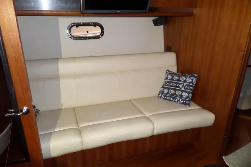 Slide: The Image of 2006 Tiara Yachts 3600 Sovran interior with cream sofa and decorative pillow. - 24