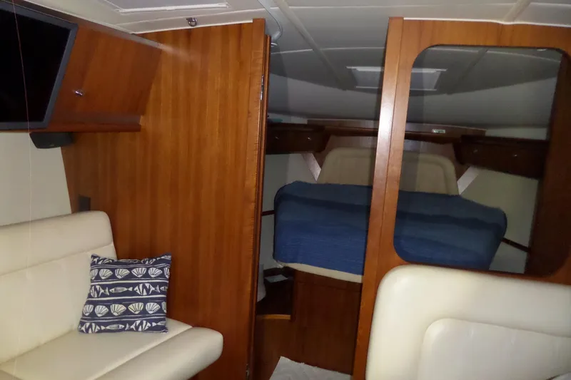 Slide: The Image of Interior of 2006 Tiara Yachts 3600 Sovran with cozy cabin and wooden finishes. - 25