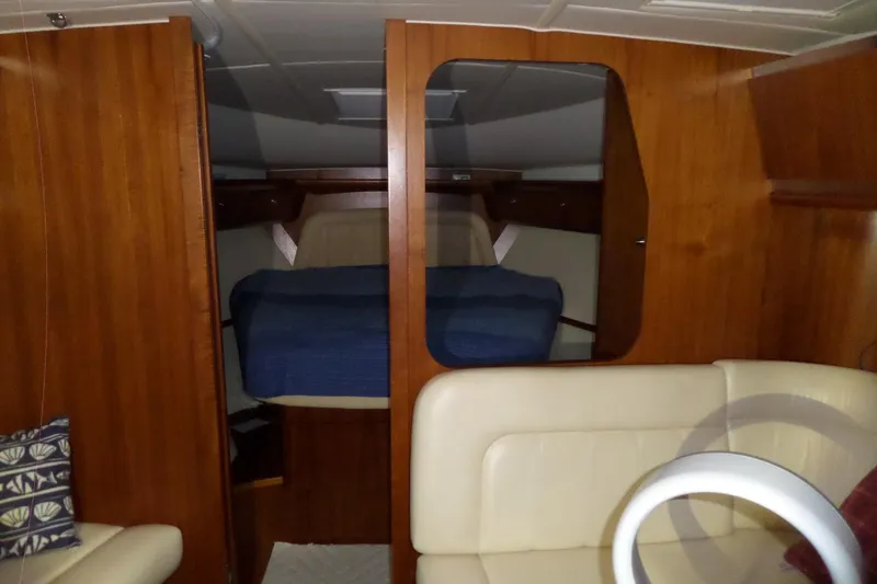 Slide: The Image of 2006 Tiara Yachts 3600 Sovran cabin interior with wood paneling and cozy seating. - 26