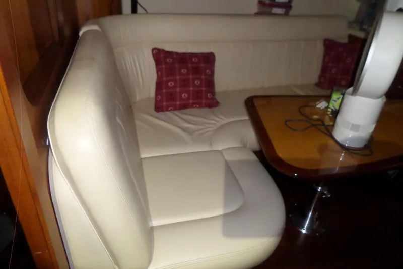 Slide: The Image of Interior of 2006 Tiara Yachts 3600 Sovran with beige seating and wooden table. - 30