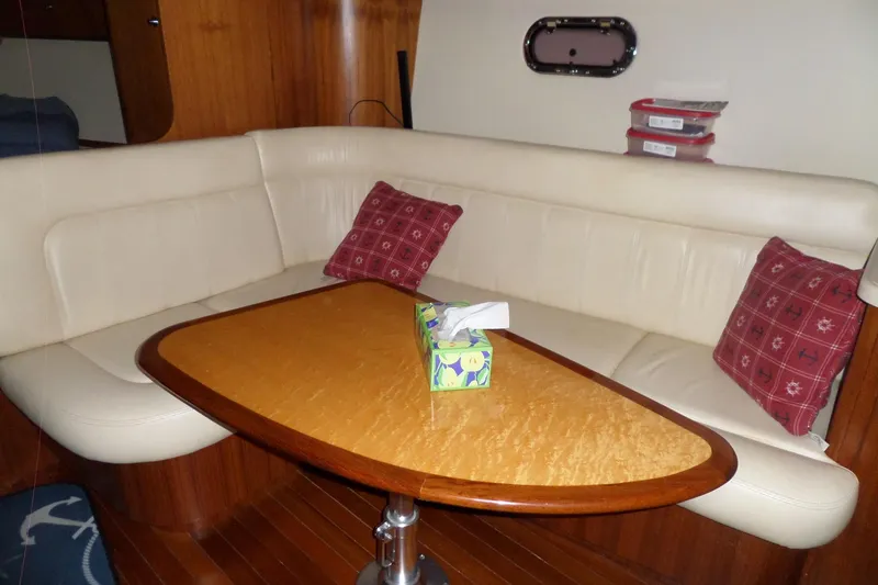 Slide: The Image of Interior of 2006 Tiara Yachts 3600 Sovran with cozy seating and wooden table. - 36