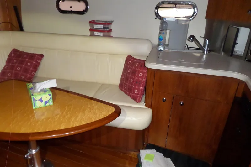 Slide: The Image of Interior of 2006 Tiara Yachts 3600 Sovran with seating, table, and kitchenette. - 37