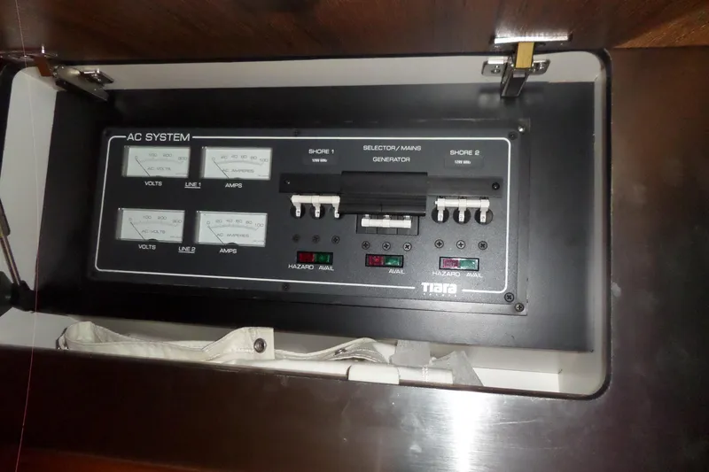 Slide: The Image of Electrical panel of a 2006 Tiara Yachts 3600 Sovran, featuring AC system controls. - 38