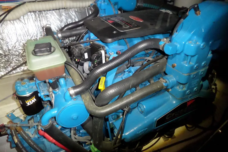 Slide: The Image of Engine of a 2006 Tiara Yachts 3600 Sovran, featuring blue components and visible wiring. - 40