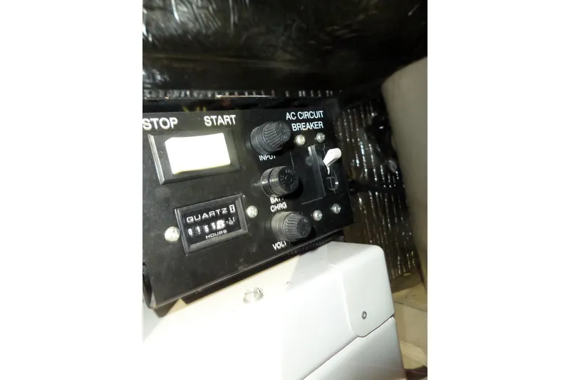 Slide: The Image of Control panel of a 2006 Tiara Yachts 3600 Sovran with AC circuit breaker and hour meter. - 44