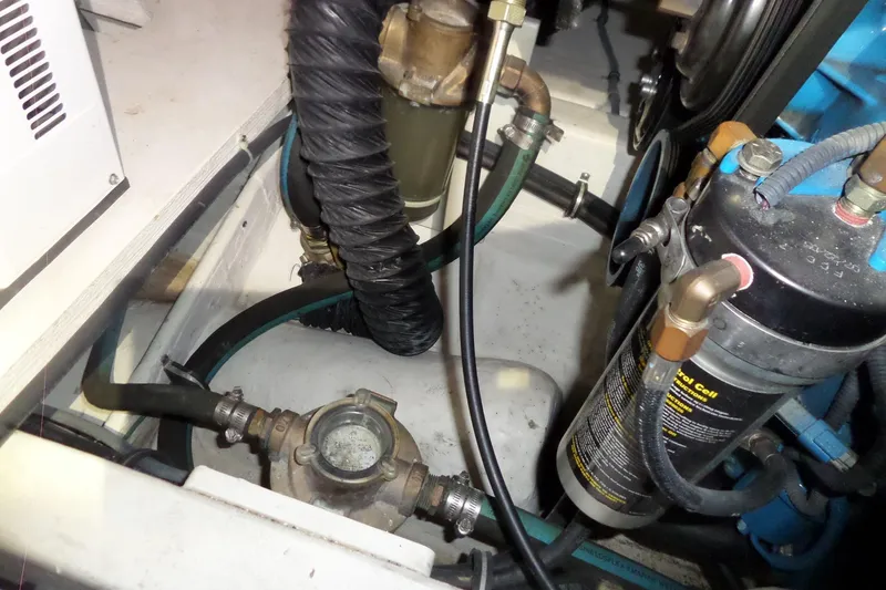 Slide: The Image of Engine compartment of a 2006 Tiara Yachts 3600 Sovran, showcasing hoses and mechanical components. - 47