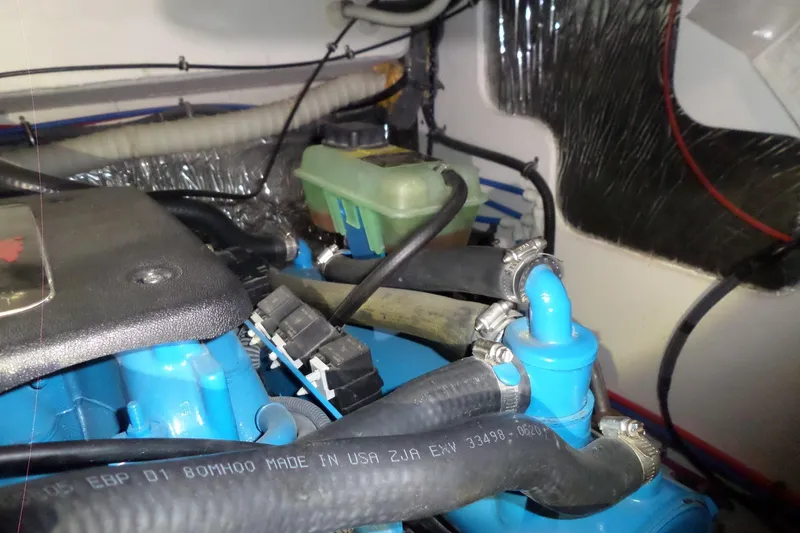 Slide: The Image of Engine compartment of a 2006 Tiara Yachts 3600 Sovran, showcasing hoses and components. - 48
