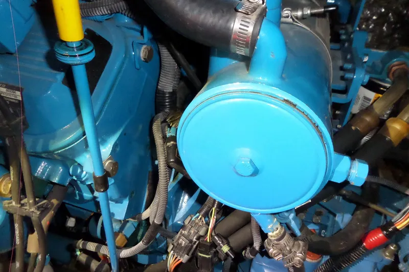 Slide: The Image of Engine components of a 2006 Tiara Yachts 3600 Sovran, featuring blue machinery and wiring. - 49