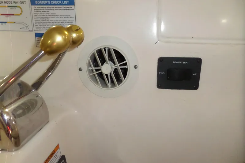 Slide: The Image of 2006 Tiara Yachts 3600 Sovran control panel with throttle, vent, and power seat switch. - 50