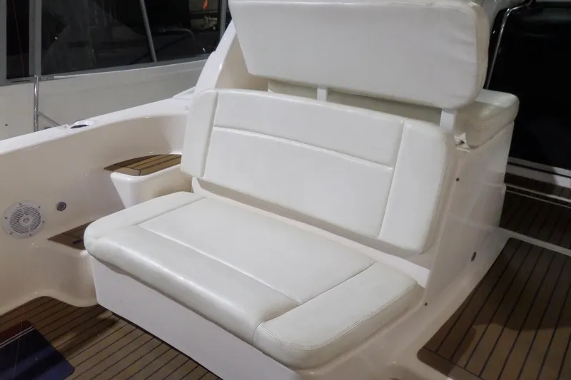 Slide: The Image of 2006 Tiara Yachts 3600 Sovran interior with white cushioned seating and teak flooring. - 8