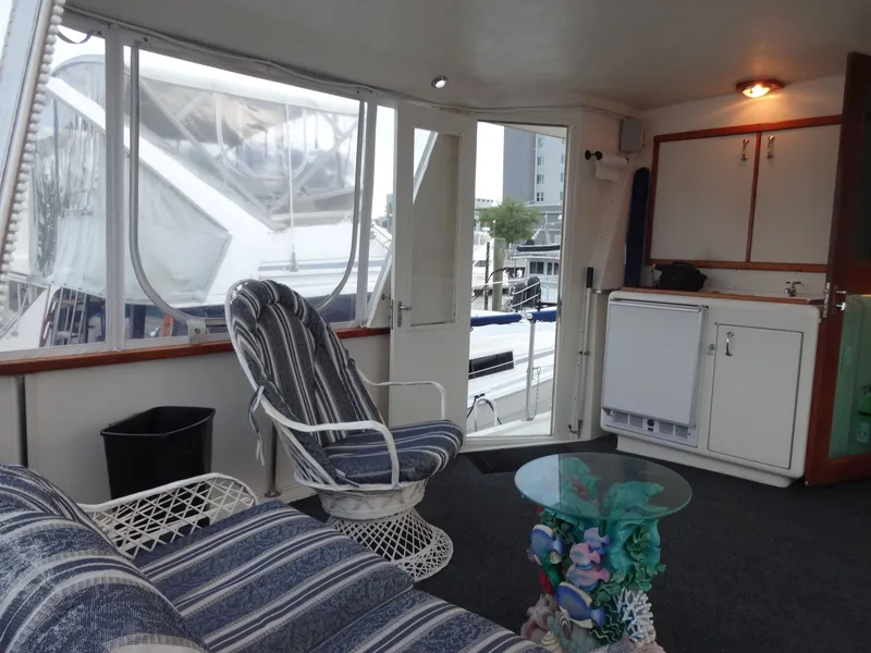 Slide: The Image of Interior of a 1987 Hatteras 43 yacht with cozy seating area. - 21