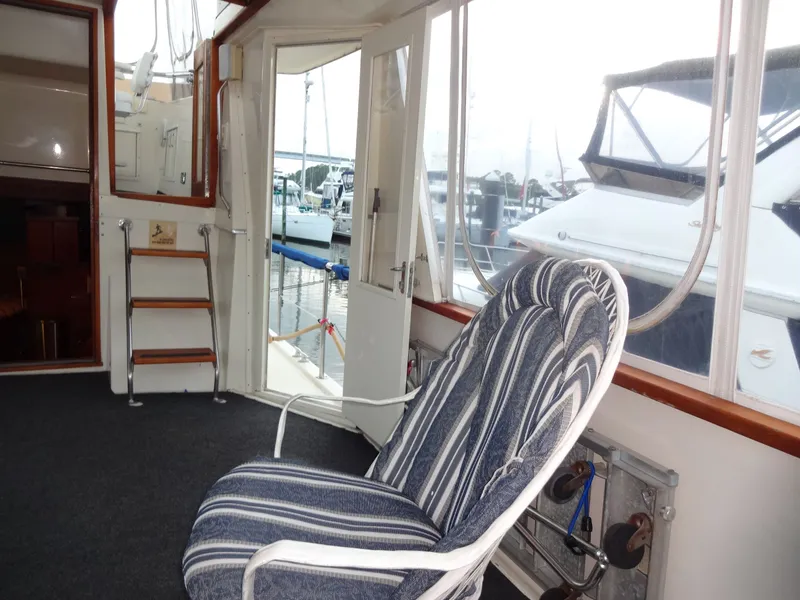 Slide: The Image of Interior of a 1987 Hatteras 43 yacht with striped chair. - 23