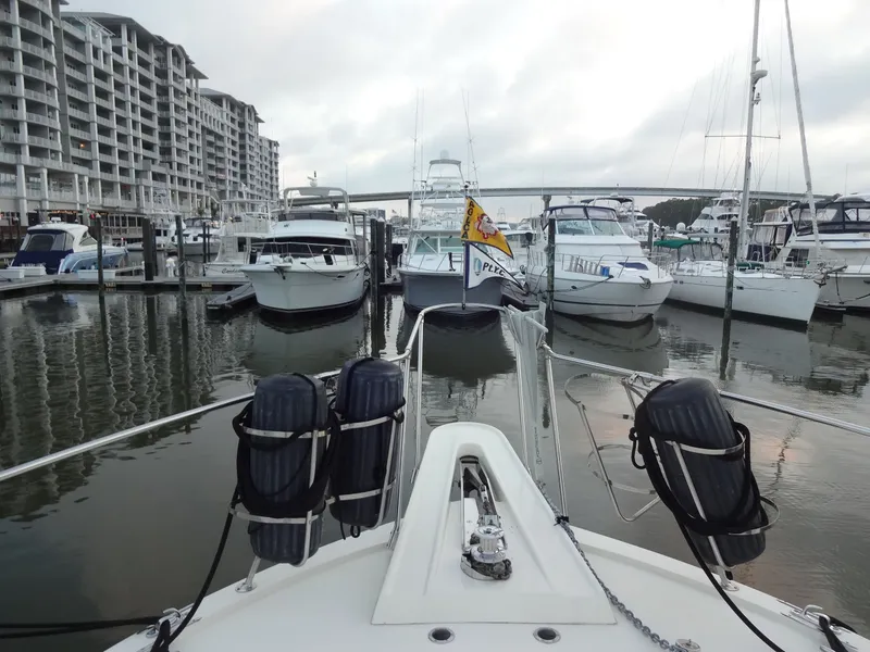 Slide: The Image of 1987 Hatteras 43 yacht docked in marina with surrounding boats. - 28