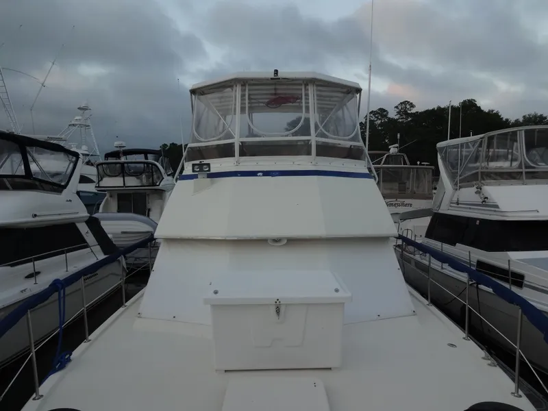 Slide: The Image of 1987 Hatteras 43 yacht docked under cloudy skies. - 29
