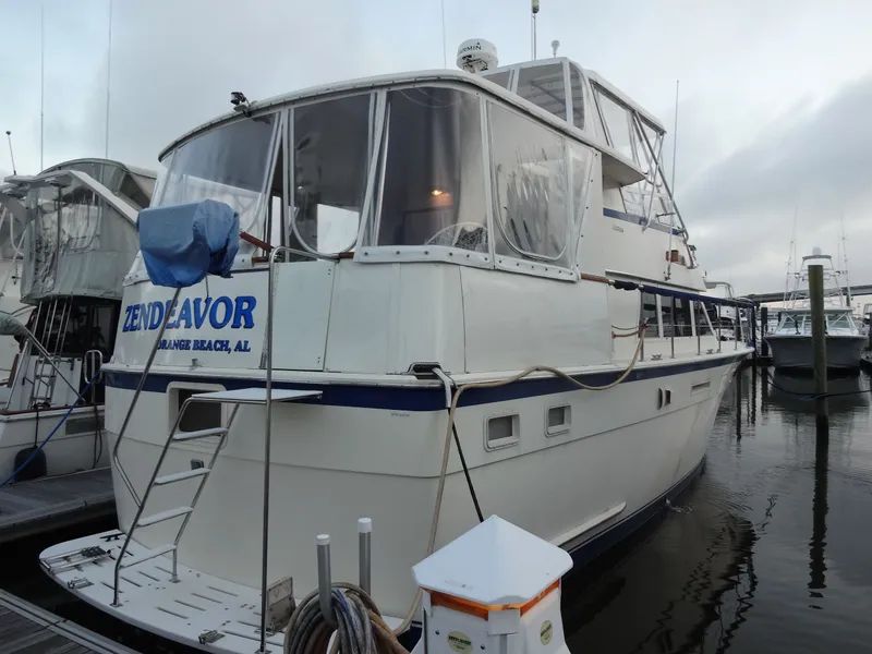Slide: The Image of 1987 Hatteras 43 yacht docked at marina. - 3
