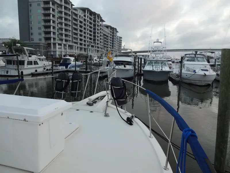 Slide: The Image of 1987 Hatteras 43 yacht docked at a modern marina. - 30