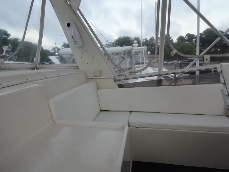 Slide: The Image of Interior of a 1987 Hatteras 43 yacht with white seating. - 35