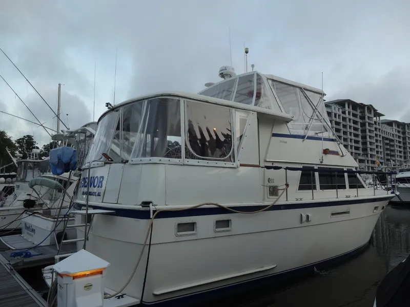 Slide: The Image of 1987 Hatteras 43 yacht docked at marina. - 4