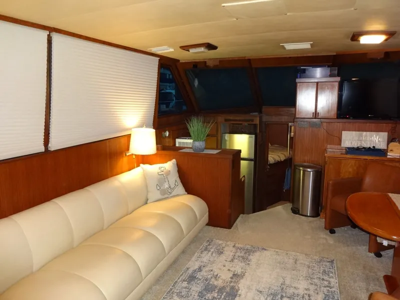 Slide: The Image of Interior of a 1987 Hatteras 43 yacht with cozy sofa and wooden furnishings. - 42