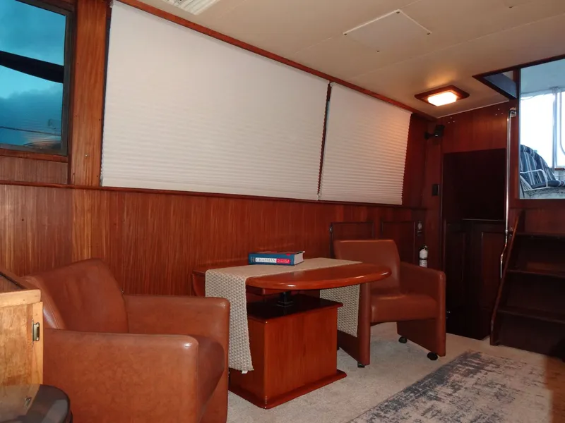 Slide: The Image of Interior of a 1987 Hatteras 43 yacht with leather chairs. - 46