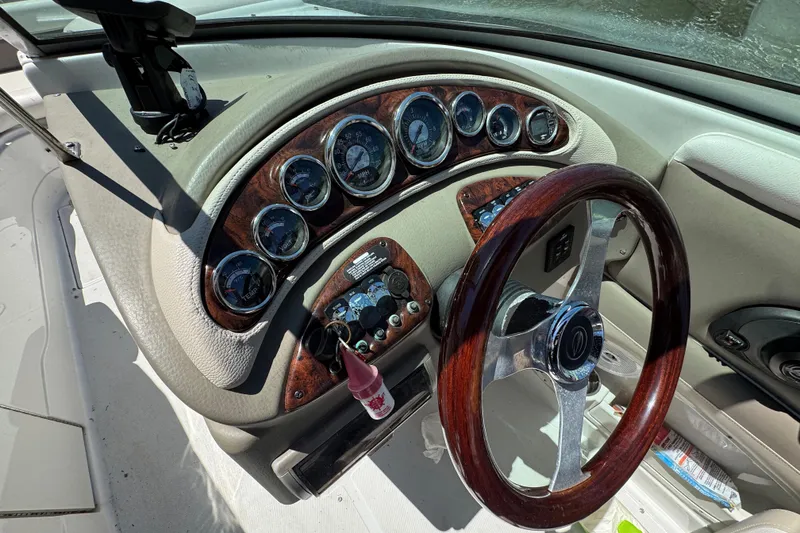 Slide: The Image of Dashboard of a 2013 Crownline Eclipse E6 XS boat with wood accents and gauges. - 12